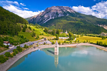 Submerged bell Tower of Curon at Graun im Vinschgau on Lake Reschen Alpine landscape aerial view,
