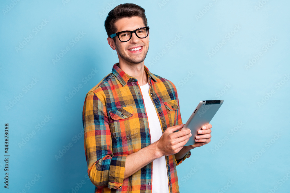 Poster portrait of attractive cheerful guy geek using device app 5g searching web isolated over bright blue