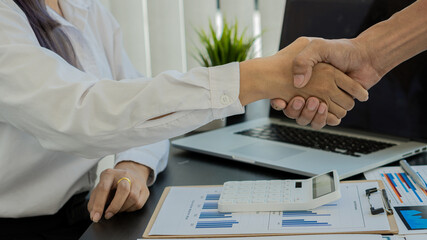 Close-up of business people shaking hands in the office after a meeting
