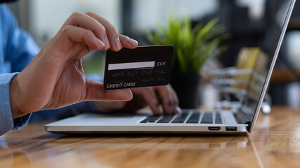 credit card mobile typing on laptop keyboard Concept of online shopping and paying through internet banks.