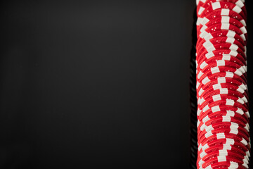 Fototapeta premium Stack of Casino gambling chips isolated on black reflective background