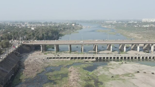 Cars driving onto Bridge towards City Skyline , Aerial birds eye view tilt up