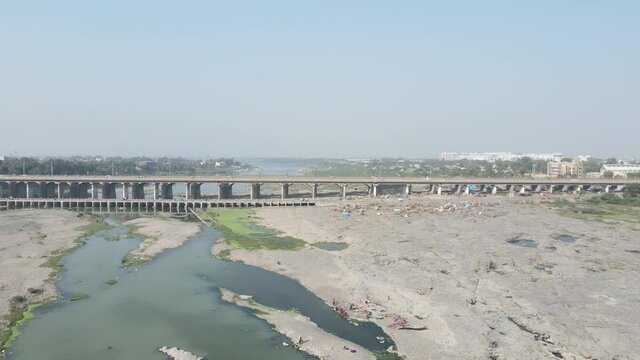 Cars driving onto Bridge towards City Skyline , Aerial birds eye view tilt up
