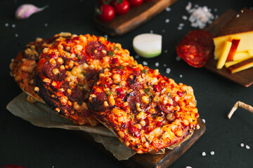 Pizza. Mini italian pizzas with cheese, pepper and tomatos. Pizza on wooden plate.