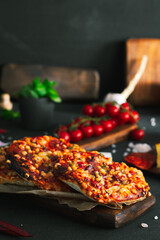 Pizza. Mini italian pizzas with cheese, pepper and tomatos. Pizza on wooden plate.