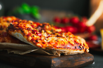 Pizza. Mini italian pizzas with cheese, pepper and tomatos. Pizza on wooden plate.