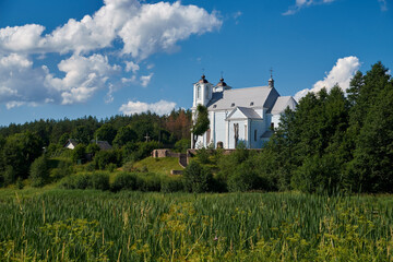 Church of the Annunciation of the Blessed Virgin Mary in Vishnevo village at summer landscape, Minsk region, Belarus.