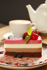 Piece of tasty mousse cake with fresh berries on plate