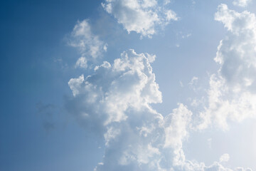 Scattered cloud clusters in a blue sky, blue sky background with white clouds,