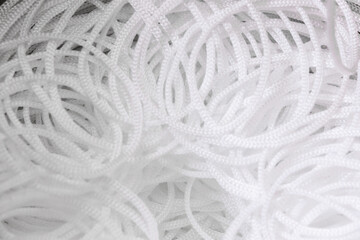 Background of pattern white synthetic cord. Industrial production of cords. Top view.