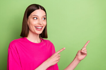 Photo of funny brunette hair millennial lady point look empty space wear pink t-shirt isolated on...