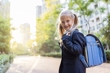 Back to school. Little girl from elementary school outdoor. Kid going learn new things 1th september