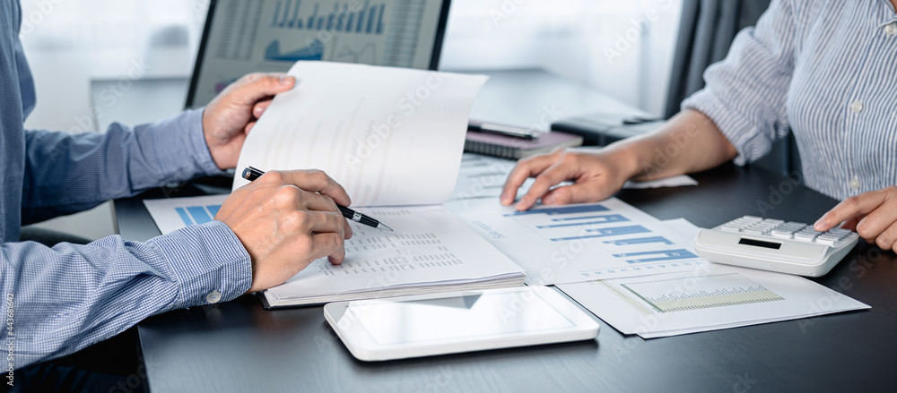 Poster Two business colleagues using calculator to checking financial report with chart document and brainstorm