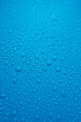 Fototapeta na wymiar water drops close up on blue background