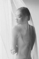Fototapeta premium Beauty fashion portrait Attractive beautiful young asian woman close eyes Charming girl use curtain cover her body Young lady has beautiful body and has perfect shape She has beauty face Get relax
