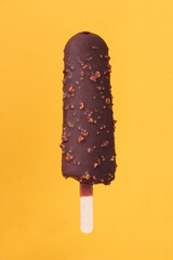 dark chocolate almond ice cream on a yellow-orange background