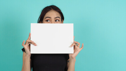 Woman hands is holding empty board on black background.Blank white A4 paper.