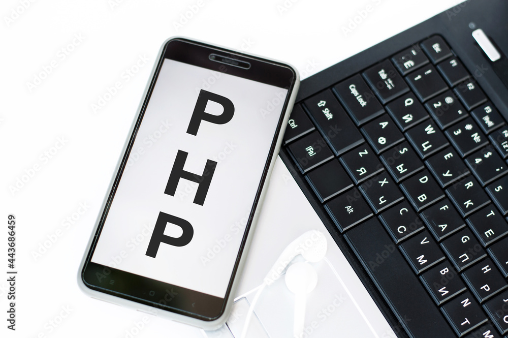 Poster phone on screen letters php next to laptop.
