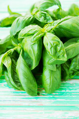 Fresh green garden basil on a rustic background
