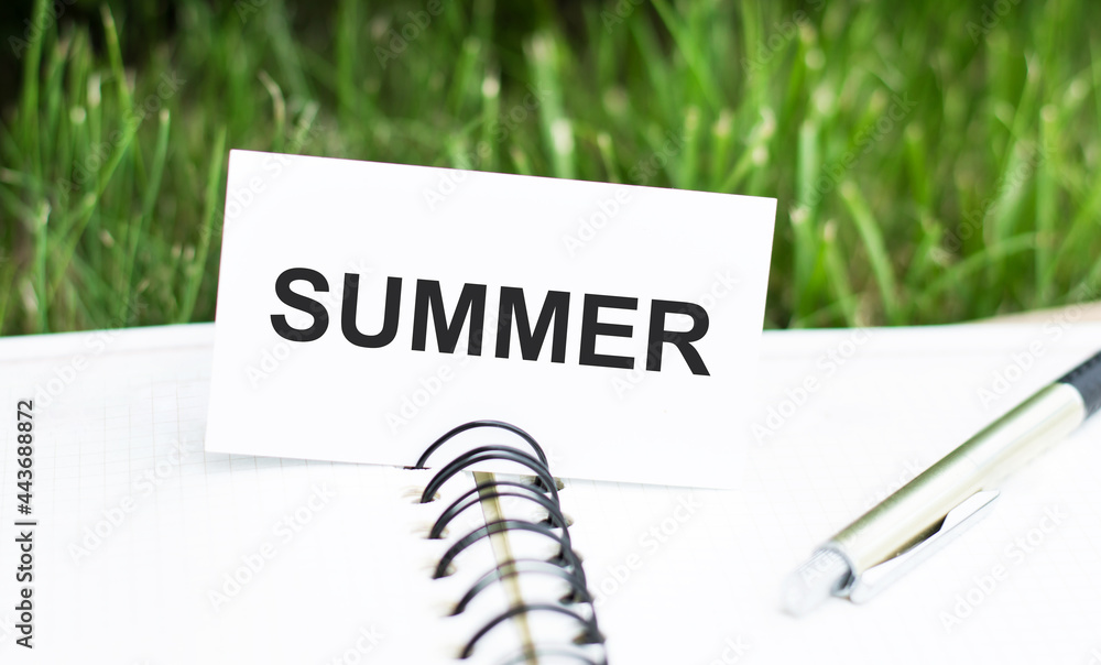 Poster summer. card with an inscription on an open blank notebook on a green background