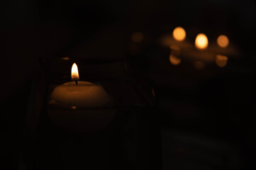 THE LIGHT OF A CANDLE IN THE DARK