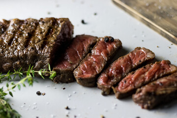 Food photograph of a medium rare cooked New York Strip steak.