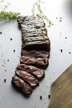 Food photograph of a medium rare cooked New York Strip steak.
