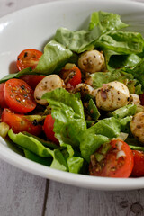 Lettuce with cherry tomatoes and mini mozzarella cheese
