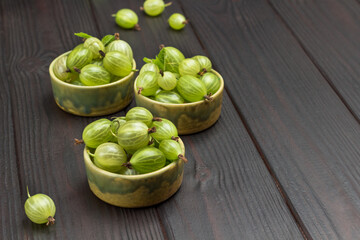 Green gooseberries in ceramic bowls