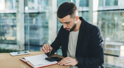 Pensive man messaging on smartphone