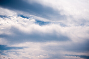 Scattered cloud clusters in a blue sky, blue sky background with white clouds,