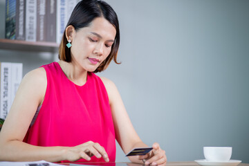 Asian woman holding a credit card to pay from an online application online shopping payment concept
