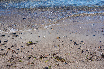 close up of sandy beach and waves at the baltic sea