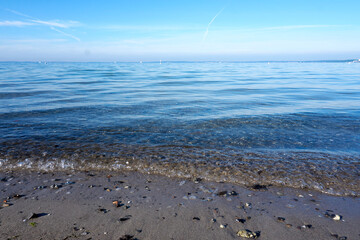 Fototapeta na wymiar close up of sandy beach and waves at the baltic sea