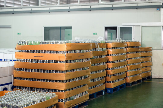Bottled juice beverage stacked in carton packaging at warehouse