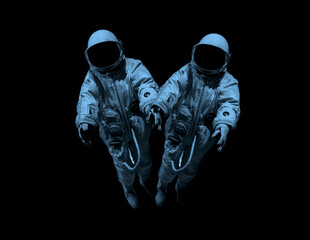 couple wearing hyperbaric astronaut protective suit. Helmet spaceman on black background. Space...