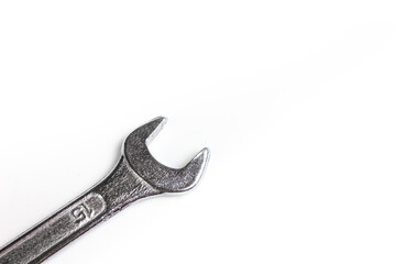 A wrench on a white background close-up. A hand tool for home repairs. The wrench head on a white background.