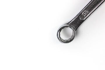 A wrench on a white background close-up. A hand tool for home repairs. The wrench head on a white background.
