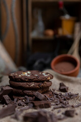 Chocolate cookies with hazelnuts , cocoa and pieces of dark chocolate on the rustic kitchen table