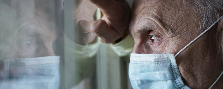Closeup side view large scale portrait of sick male patient wearing face mask