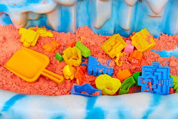 colored kinetic sand and plastic children's toys