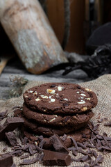 Chocolate cookies with hazelnuts , cocoa and pieces of dark chocolate on the rustic kitchen table