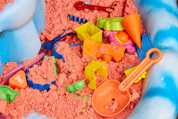 colored kinetic sand and plastic children's toys