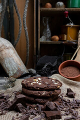 Chocolate cookies with hazelnuts , cocoa and pieces of dark chocolate on the rustic kitchen table