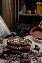 Chocolate cookies with hazelnuts , cocoa and pieces of dark chocolate on the rustic kitchen table