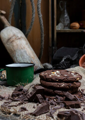 Chocolate cookies with hazelnuts , cocoa and pieces of dark chocolate on the rustic kitchen table