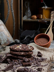 Chocolate cookies with hazelnuts , cocoa and pieces of dark chocolate on the rustic kitchen table