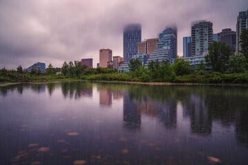 Fototapeta na wymiar Rain Falling Over A Downtown Calgary Summer Park