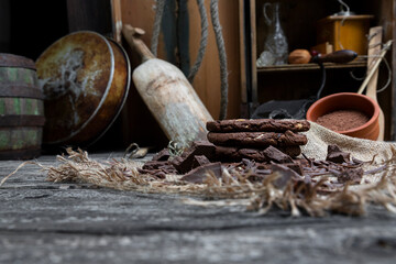 Chocolate cookies with hazelnuts , cocoa and pieces of dark chocolate on the rustic kitchen table