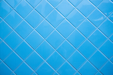 Light blue background. Ceramic, mosaic, classic and vintage. Texture design. Reflections of light on the old and restored wall. Home interior, pool, diagonal, backdrop.